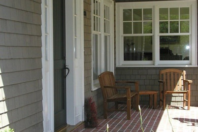 Mid-sized classic brick front porch idea in San Francisco with a roof extension