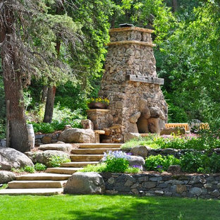 Traditional backyard garden in Denver with with fireplace.