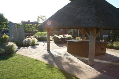 Inspiration for a contemporary back xeriscape full sun garden for summer in Other with natural stone paving.