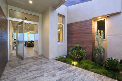 Entryway - transitional ceramic tile entryway idea in Orange County with beige walls and a glass front door
