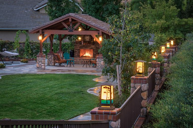 Inspiration for a large timeless brown one-story stone exterior home remodel in Los Angeles with a tile roof