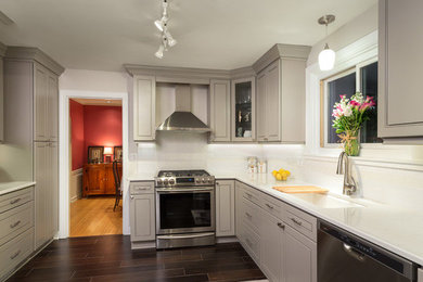 Example of a mid-sized minimalist u-shaped dark wood floor enclosed kitchen design in Chicago with an undermount sink, raised-panel cabinets, gray cabinets, quartzite countertops, white backsplash, subway tile backsplash, stainless steel appliances and no island