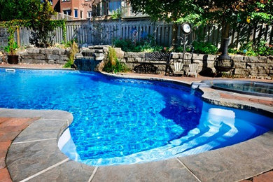 Inspiration for a large timeless backyard concrete paver and custom-shaped lap pool fountain remodel in Charleston