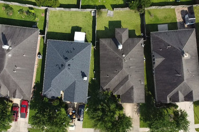 Example of a mid-sized classic one-story house exterior design in Other with a hip roof, a shingle roof and a black roof