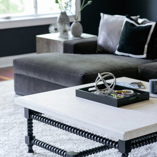 Photo of a large contemporary enclosed home cinema in Nashville with black walls, medium hardwood flooring and a projector screen.