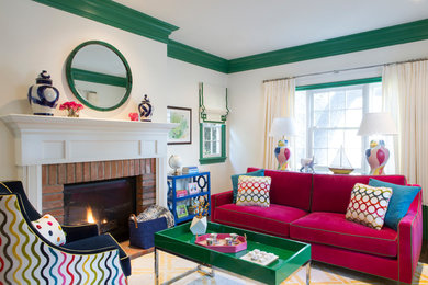 Example of a medium tone wood floor and brown floor living room design in Los Angeles with white walls, a standard fireplace, a brick fireplace and no tv