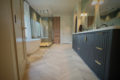 Inspiration for a large transitional master green tile and ceramic tile porcelain tile, brown floor and double-sink bathroom remodel in Atlanta with furniture-like cabinets, black cabinets, a freestanding vanity, a one-piece toilet, brown walls, an undermount sink, marble countertops, a hinged shower door and white countertops