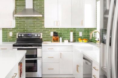 Minimalist kitchen photo in Phoenix with green backsplash