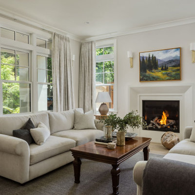 Inspiration for a mid-sized transitional formal and open concept medium tone wood floor and gray floor living room remodel in San Francisco with white walls, a standard fireplace, a plaster fireplace and no tv