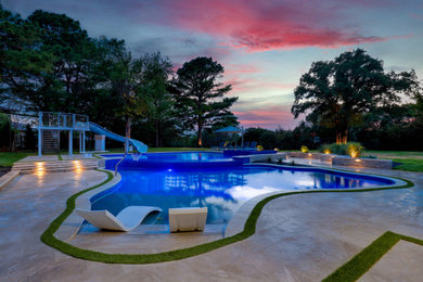 Inspiration for a mid-sized backyard stone and custom-shaped water slide remodel in Dallas