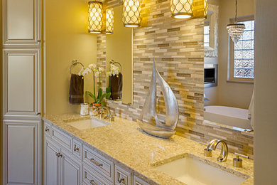 Example of a mid-sized transitional master multicolored tile and mosaic tile porcelain tile bathroom design in Phoenix with an undermount sink, raised-panel cabinets, white cabinets, quartz countertops, a one-piece toilet and beige walls
