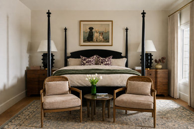 Example of a classic medium tone wood floor and brown floor bedroom design in San Diego with beige walls