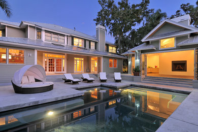 Example of a small trendy backyard concrete and rectangular pool house design in Tampa