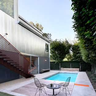 シアトルの中サイズの長方形インダストリアルスタイルのおしゃれなプール (コンクリート板舗装	) の写真