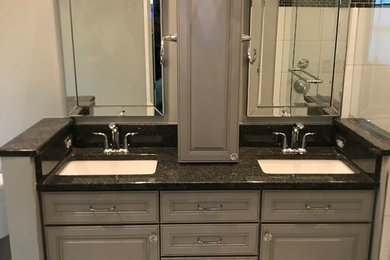 Example of a mid-sized classic master marble floor and gray floor bathroom design in DC Metro with raised-panel cabinets, gray cabinets, gray walls, an undermount sink and granite countertops