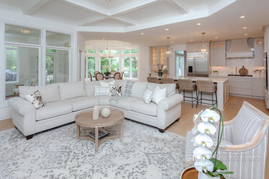 Example of a classic open concept light wood floor and coffered ceiling family room design in Other with white walls