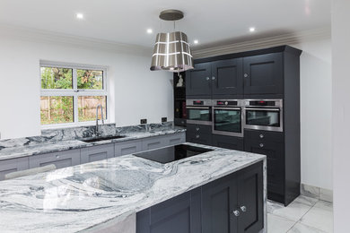 Design ideas for an expansive modern kitchen/diner in Other with a double-bowl sink, black cabinets, granite worktops, multi-coloured splashback, stone tiled splashback, black appliances, marble flooring, an island, multi-coloured floors and multicoloured worktops.