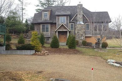 Example of a mountain style brown three-story wood exterior home design in Charlotte