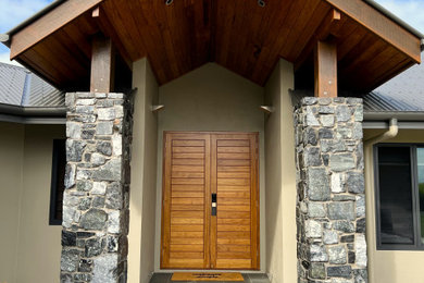 他の地域にあるモダンスタイルのおしゃれな玄関 (白い壁、濃色無垢フローリング、木目調のドア) の写真