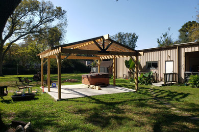 Patio - backyard concrete patio idea in Houston with a pergola