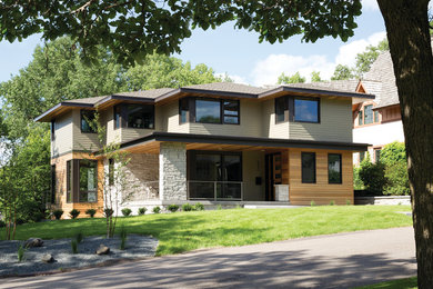 Large contemporary beige two-story mixed siding house exterior idea in Chicago with a hip roof and a shingle roof