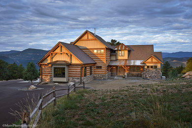 This is an example of a large traditional two-storey beige exterior in Denver with wood siding.