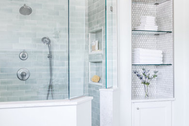 Photo of a transitional master bathroom in Boston with recessed-panel cabinets, white cabinets, a freestanding tub, a curbless shower, a one-piece toilet, green tile, ceramic tile, marble floors, an undermount sink, marble benchtops, grey floor, an open shower and grey benchtops.