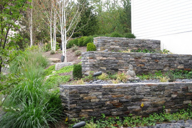 Photo of a small rustic shade backyard retaining wall landscape in New York.