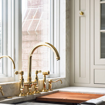 Elegant Two-Tone Kitchen with Walnut Cabinetry and Statement Stone Backsplash