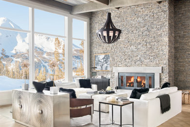 Living room - rustic open concept medium tone wood floor, brown floor, exposed beam and wood ceiling living room idea in Other with gray walls, a standard fireplace and a stone fireplace