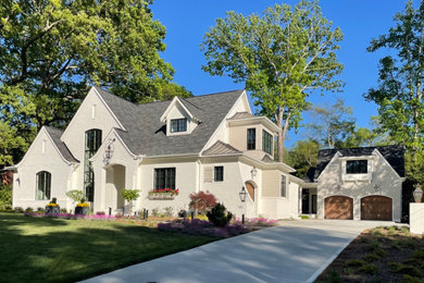 Inspiration for a large transitional white two-story brick and clapboard exterior home remodel in Charlotte with a shingle roof and a black roof