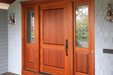 Entryway - traditional entryway idea in New York with a medium wood front door