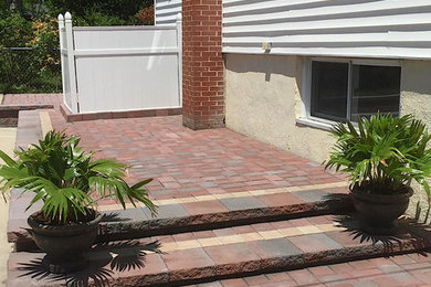Mid-sized elegant backyard stone patio photo in Baltimore with no cover