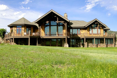 Large arts and crafts brown two-story wood exterior home photo in Denver