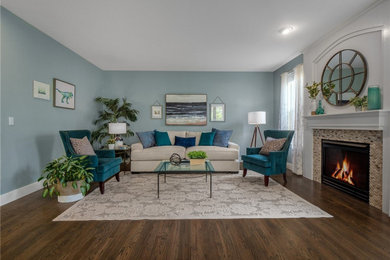 Inspiration for a mid-sized transitional open concept medium tone wood floor and brown floor family room remodel in Seattle with blue walls, a standard fireplace and a stone fireplace