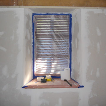 Adobe house dust control. Sheetrock level finish in bedroom.