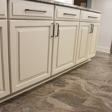 Beige Kitchen with Extra Large Island, Tile Backsplash and Granite Countertops