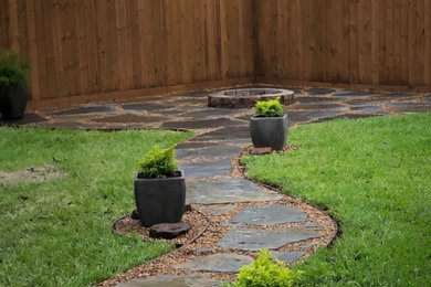 Backyard flagstone walking path with firepit and seating area