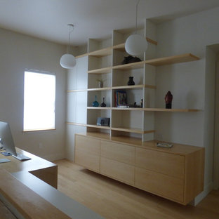 Design ideas for a medium sized modern study in Boston with white walls, no fireplace, a freestanding desk and bamboo flooring.