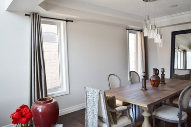 Example of a mid-sized transitional dark wood floor and brown floor great room design in Toronto with white walls and no fireplace