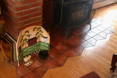 Living room - traditional light wood floor living room idea in Other with a wood stove, a brick fireplace and no tv