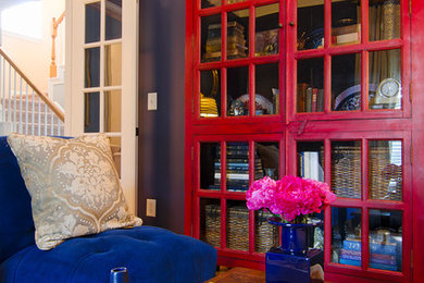 Small elegant enclosed medium tone wood floor family room library photo in Charlotte with blue walls and no tv