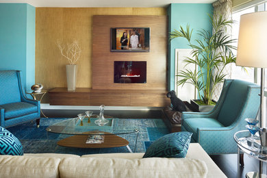 Small modern open concept living room in New York with blue walls, medium hardwood floors and a wall-mounted tv.