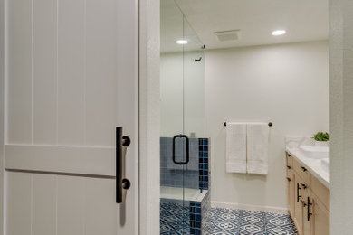 Mid-sized transitional master blue tile and subway tile ceramic tile, blue floor and double-sink bathroom photo in Other with shaker cabinets, light wood cabinets, white walls, a vessel sink, quartz countertops, a hinged shower door, white countertops and a built-in vanity