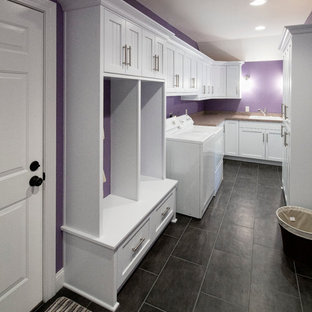 Utility room in Other with shaker cabinets, white cabinets, purple walls and a side by side washer and dryer.