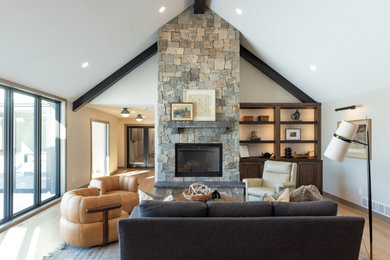 Example of a transitional light wood floor and exposed beam living room design in Other