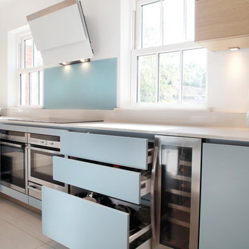 Handle-less matt blue & wood effect kitchen with lots of storage