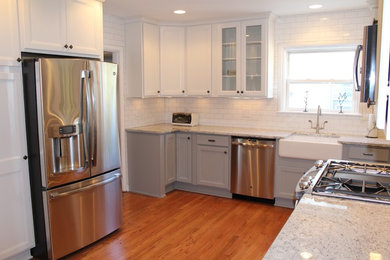 Inspiration for a small eclectic l-shaped medium tone wood floor eat-in kitchen remodel in Columbus with a farmhouse sink, shaker cabinets, white cabinets, granite countertops, white backsplash, ceramic backsplash and stainless steel appliances