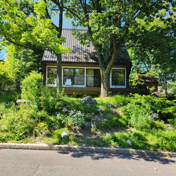 Deck with black metal post cable railing in Quebec, Canada