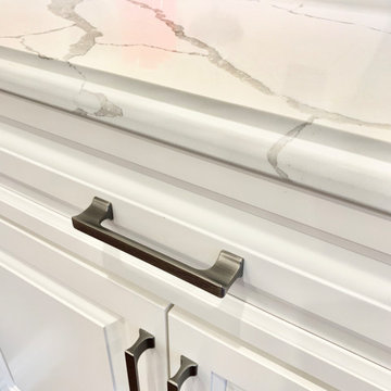 Ivory White Kitchen With Marble Look Quartz Counters and Splash